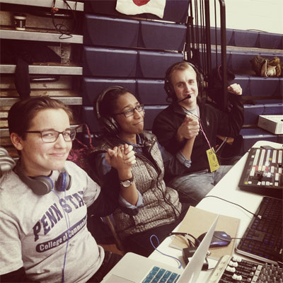 Students raise their hands up to celebrate on the
production of the THON webcast