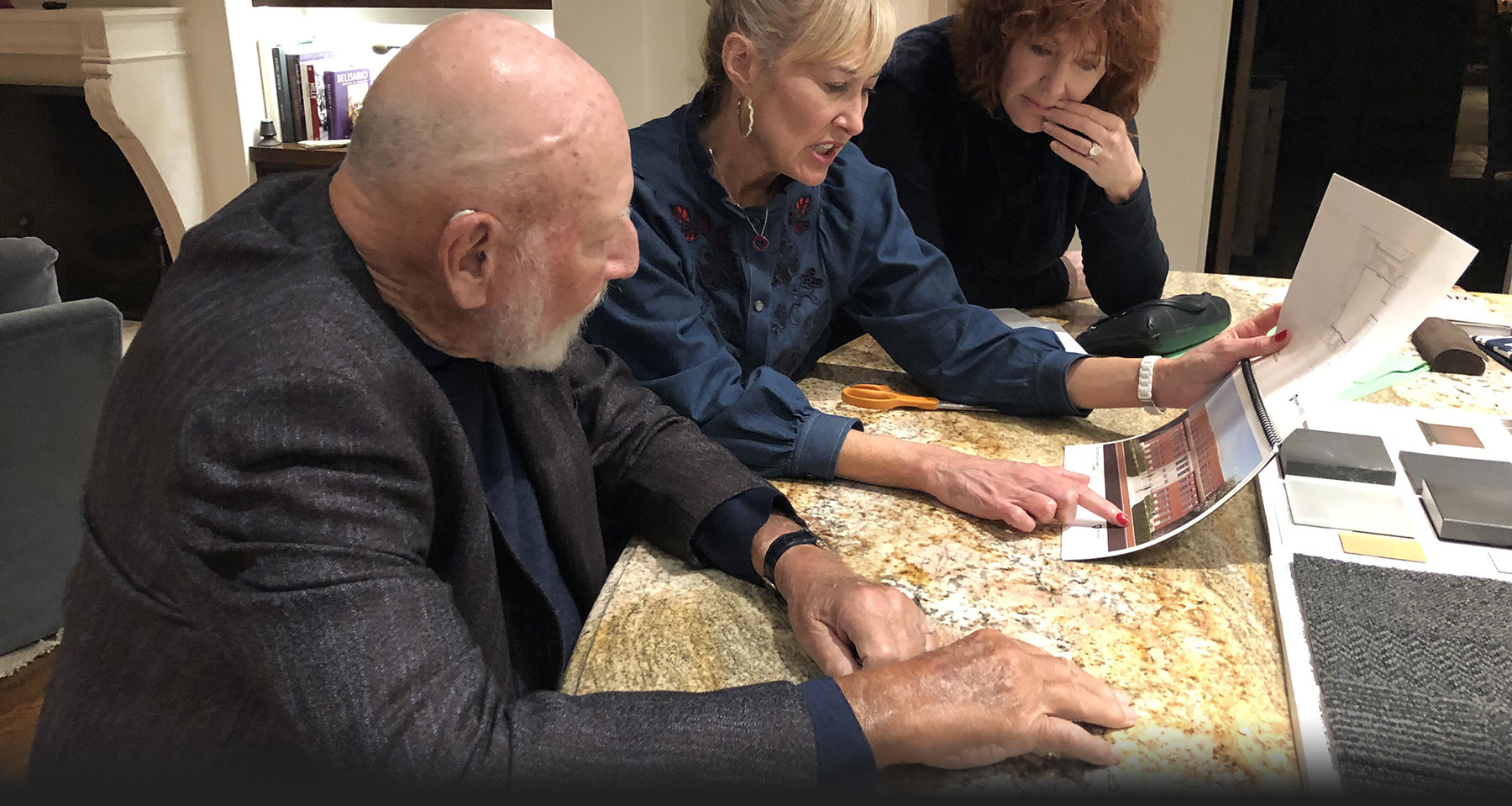 Dean Marie Hardin shows Donald and Vivienne Bellisario plans and blueprints for the new Donald
	P. Bellisario Media Center center construction.