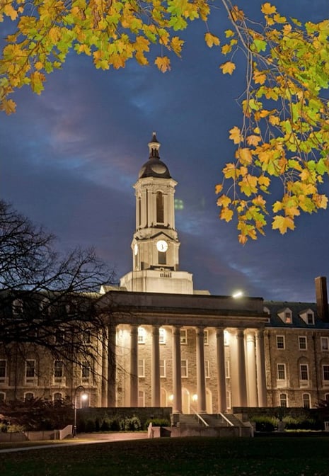 Old Main, the main administration building, lit up at night.