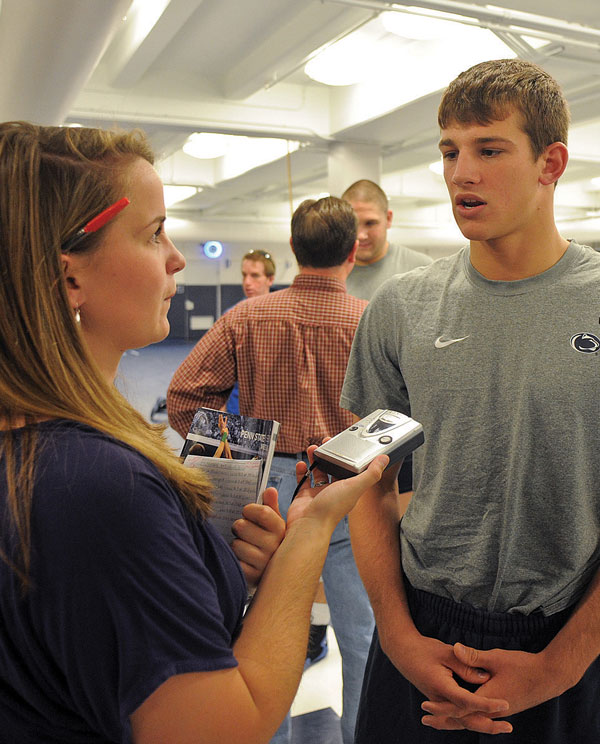 Student interviewing a Penn State wrestler