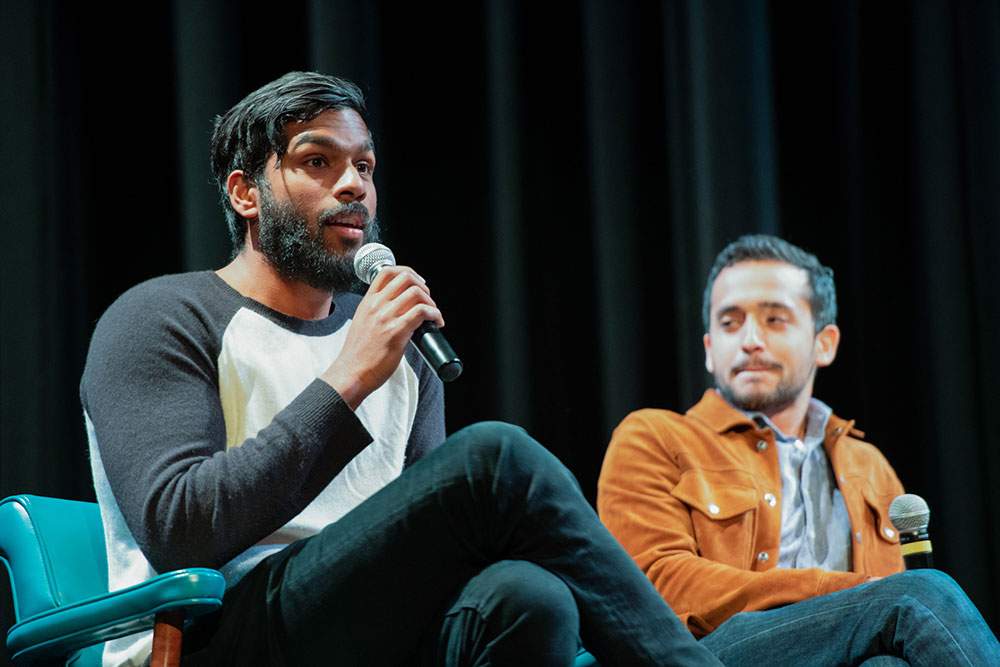 Two speakers on stage at a panel event