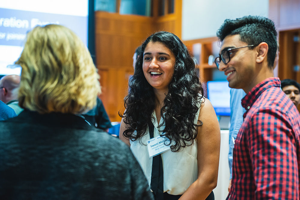 Students in conversation at a recruiting event