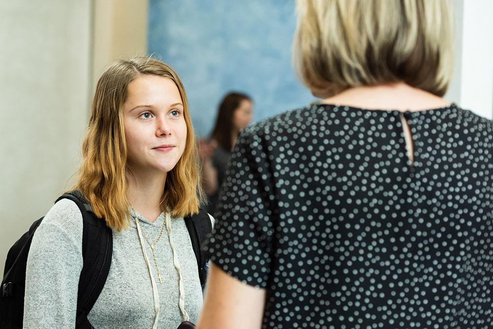 Student talking to a guest speaker after an event