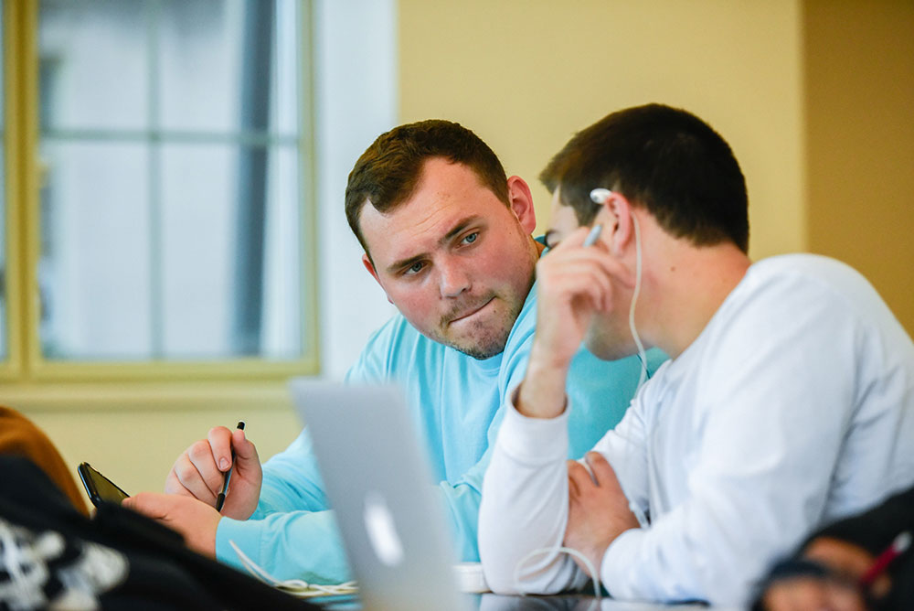 Students in conversation over a group project