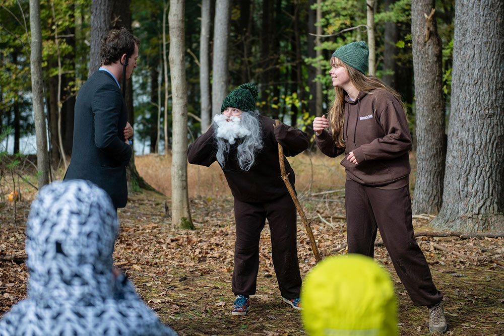 Kid in a fake beard at a theatre presentation