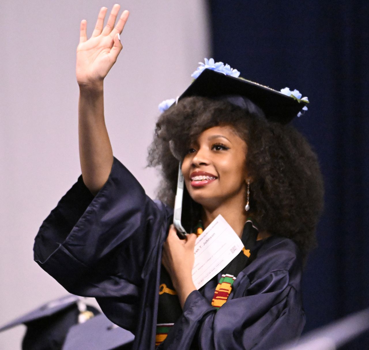 Waving student at graduation