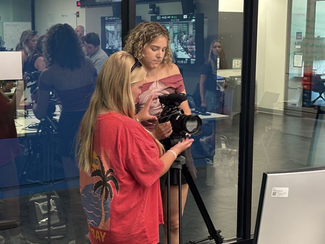 Two girls try a camera