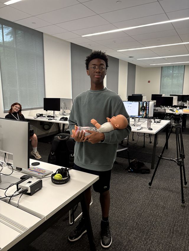 Student with prop baby