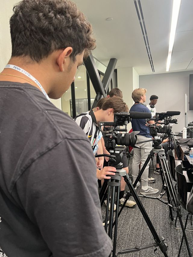 A row of students and tripods