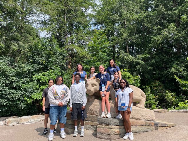 Group standing at Nittany Lion shrine.