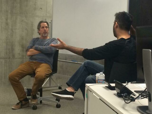 Two Hollywood professionals sit in front of a class of students.