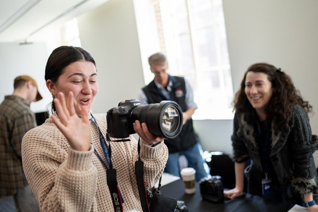 A student smiles while testing a camera