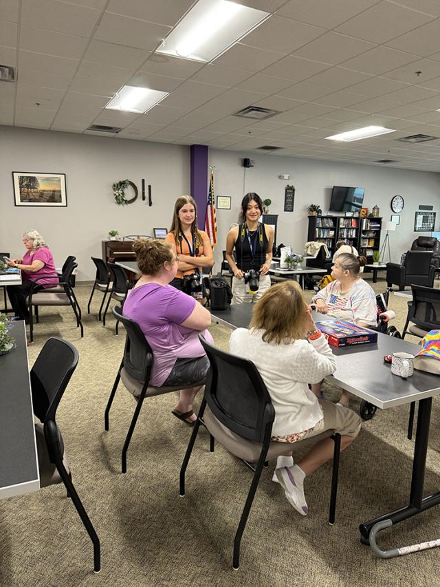Two students talking to retirees