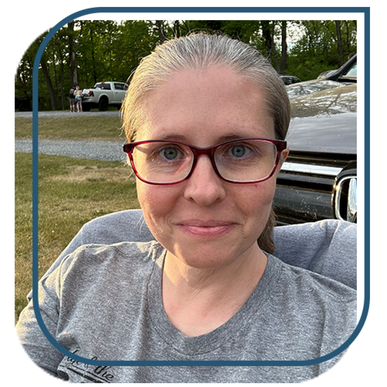 woman in a gray t-shirt and glasses