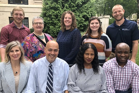 Staff photograph of the nine-person advising team