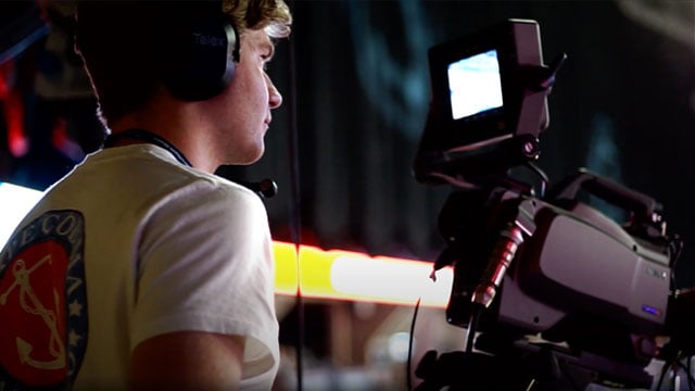 A student operating a camera in the Bryce Jordan Center