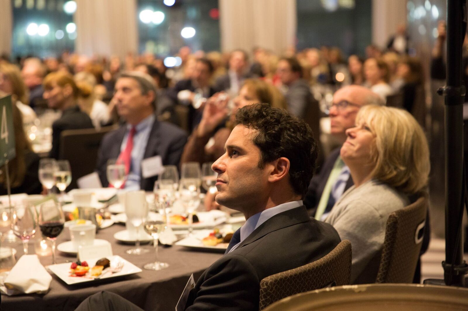 Members of the audience listen to event MC Bill Nielsen discuss the importance of truth in communications.