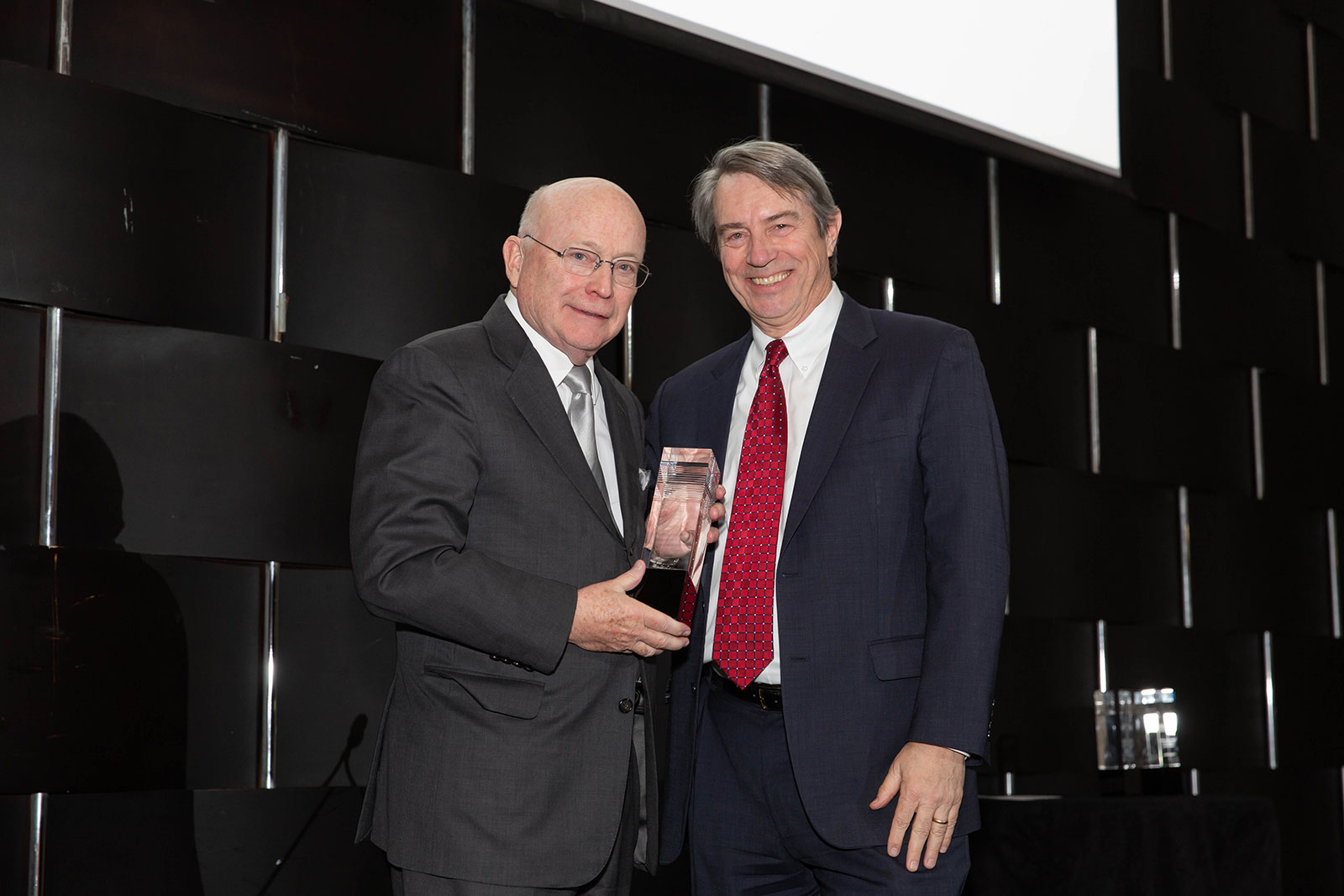 Honoree Jack Rowe (left) poses with Roger Bolton and the 2019 Larry Foster Award trophy. 