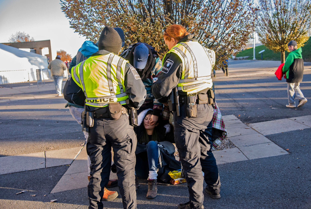 Several police officers assist a fan.
