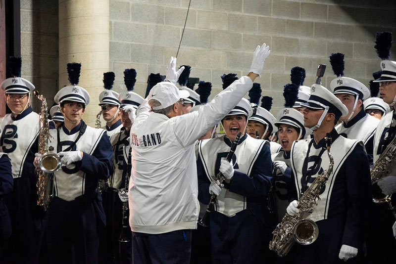 Dave Cree with his hands in the air preps to release the Blue Band onto the field.