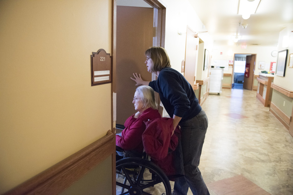 Lisa helps her mother Elaine into her room.